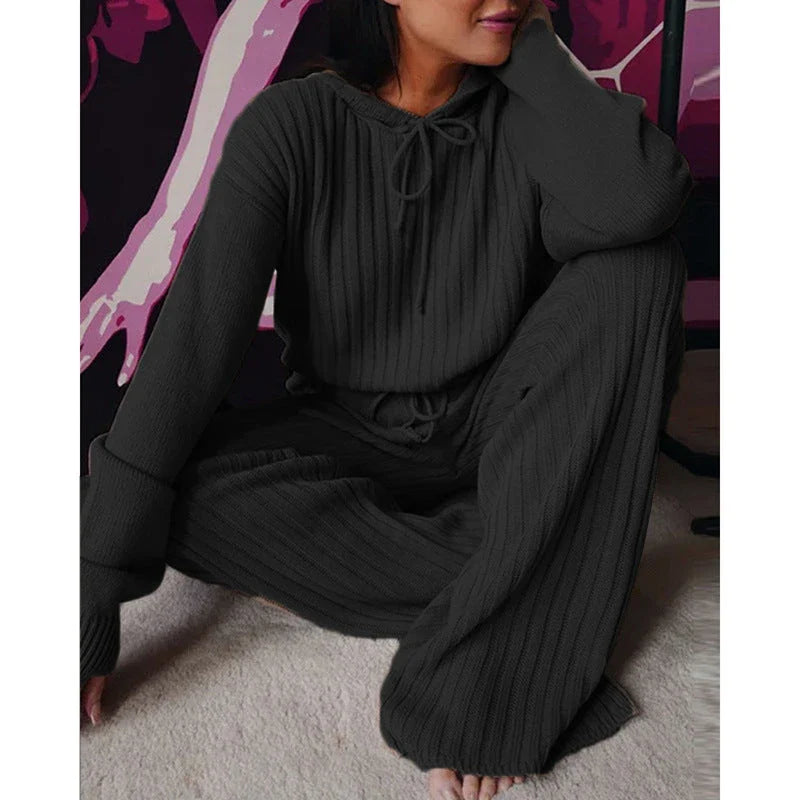 A stylish two-piece casual set featuring a hooded top with long sleeves and matching bottoms in a variety of vibrant colors.