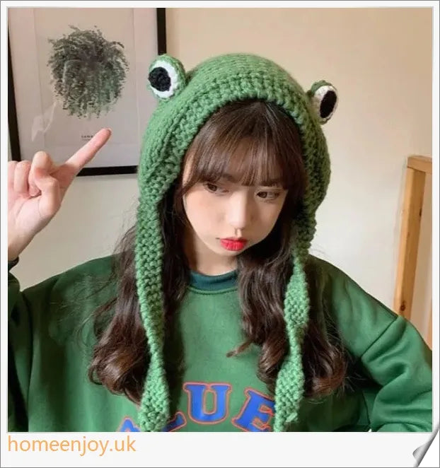 A cosy and stylish woollen hat featuring a charming cartoon frog design with big, expressive eyes