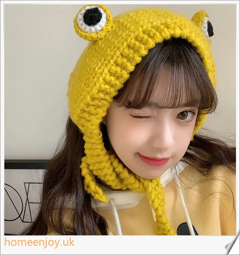 A cosy and stylish woollen hat featuring a charming cartoon frog design with big, expressive eyes