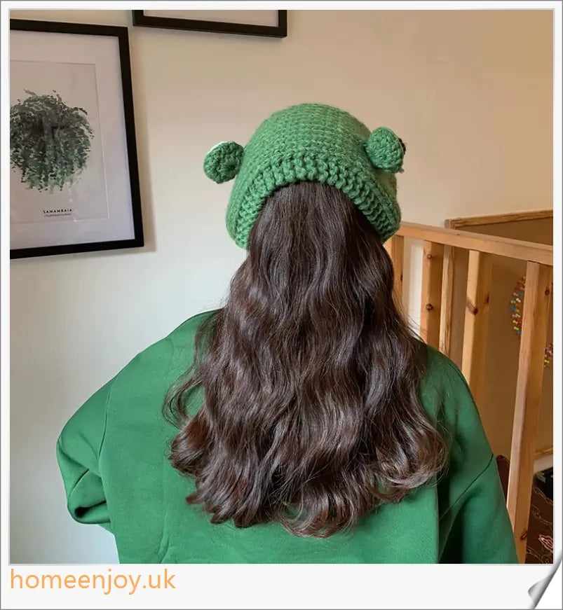 A cosy and stylish woollen hat featuring a charming cartoon frog design with big, expressive eyes
