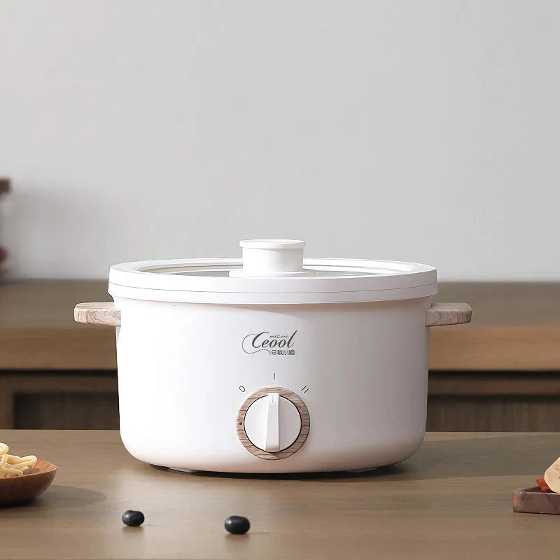 Multifunction Mini Electric Cooking Pot with Food Steamer - A compact and versatile kitchen appliance with non-stick surface and steamer attachment.