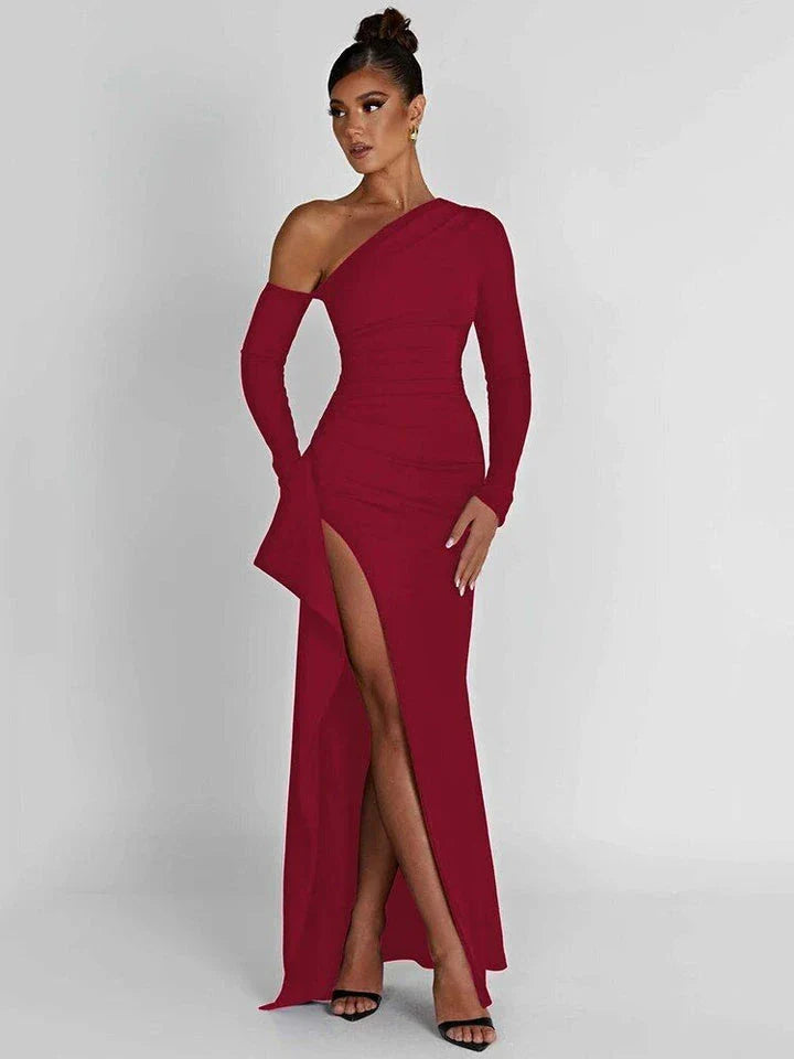 Elegant wine red maxi dress with oblique shoulder design, thigh-high split, and backless feature for sophisticated evening wear