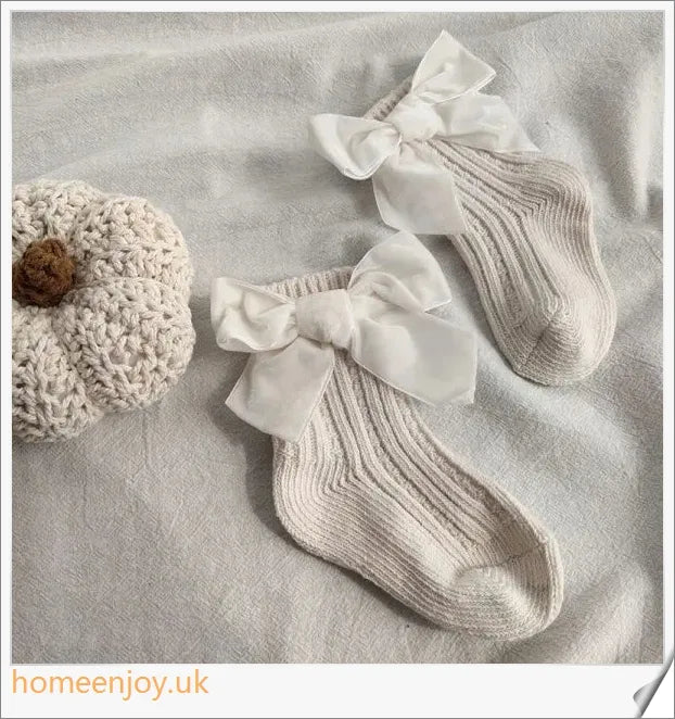 Soft, cosy baby socks with a charming bowknot design, available in a variety of classic colours