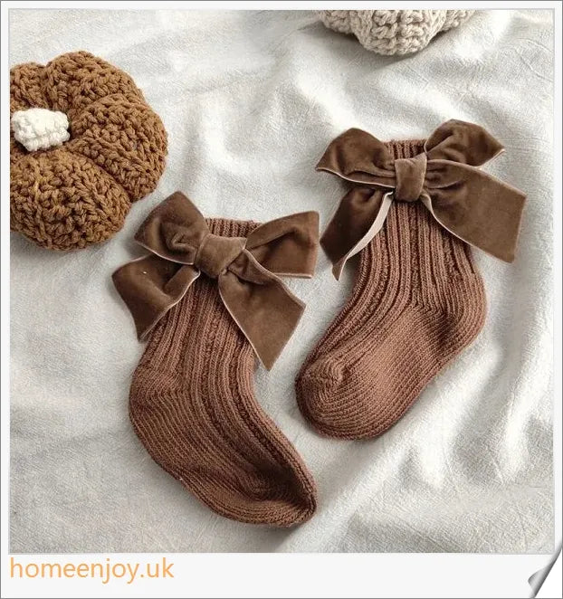 Soft, cosy baby socks with a charming bowknot design, available in a variety of classic colours
