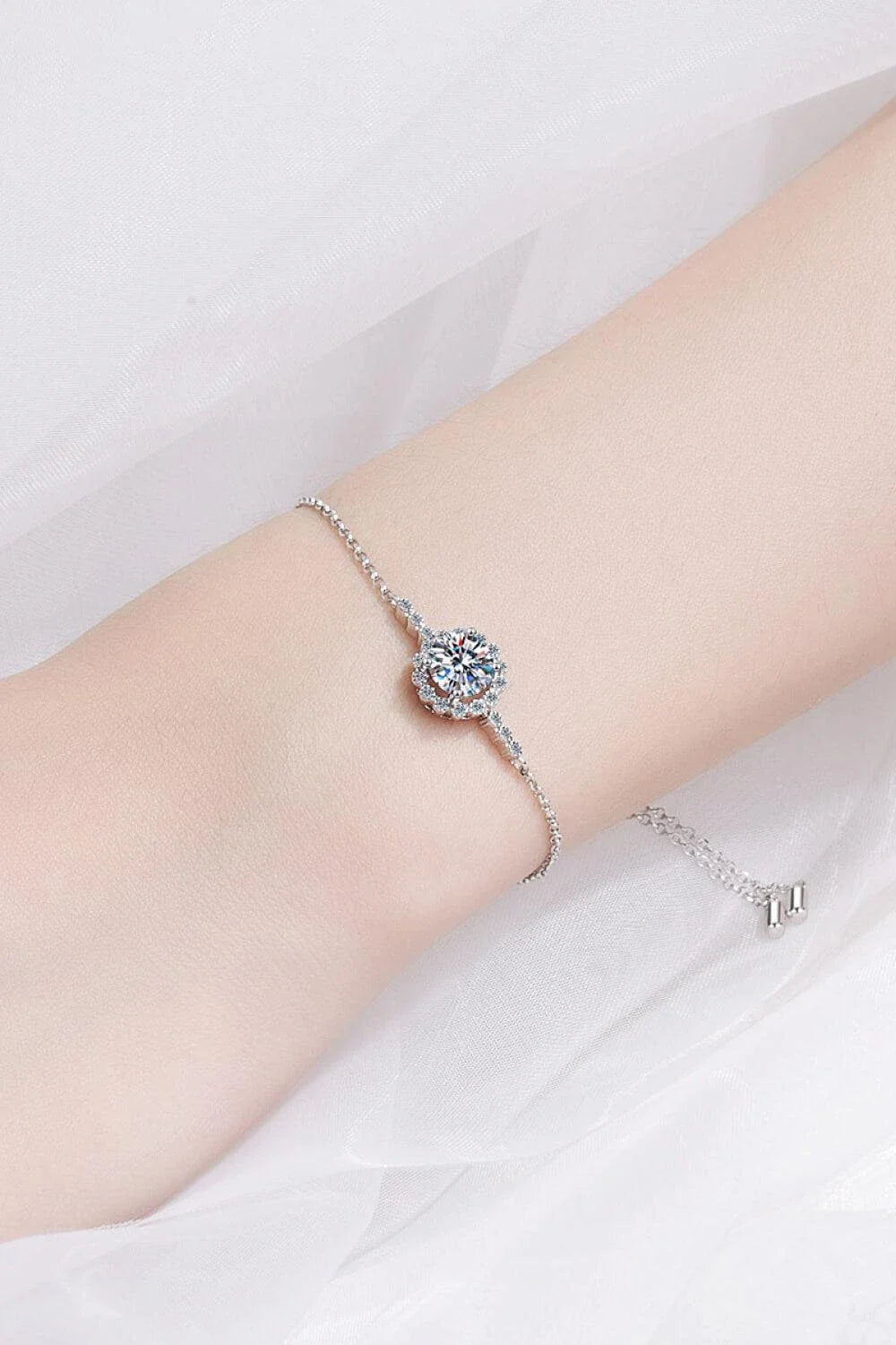 A close-up of a 1 carat moissanite chain bracelet made with 925 sterling silver and zircon accent stones.