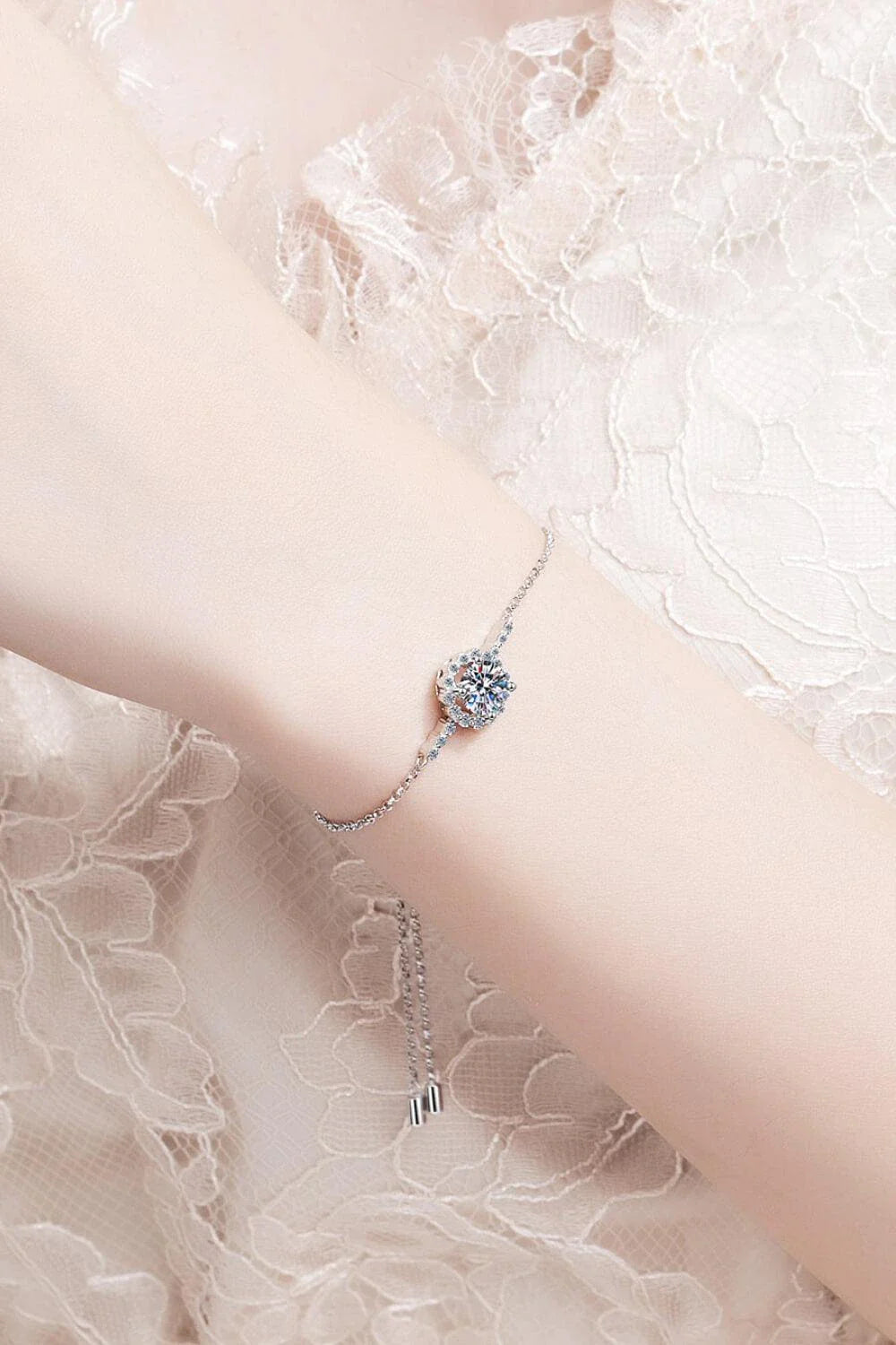 A close-up of a 1 carat moissanite chain bracelet made with 925 sterling silver and zircon accent stones.