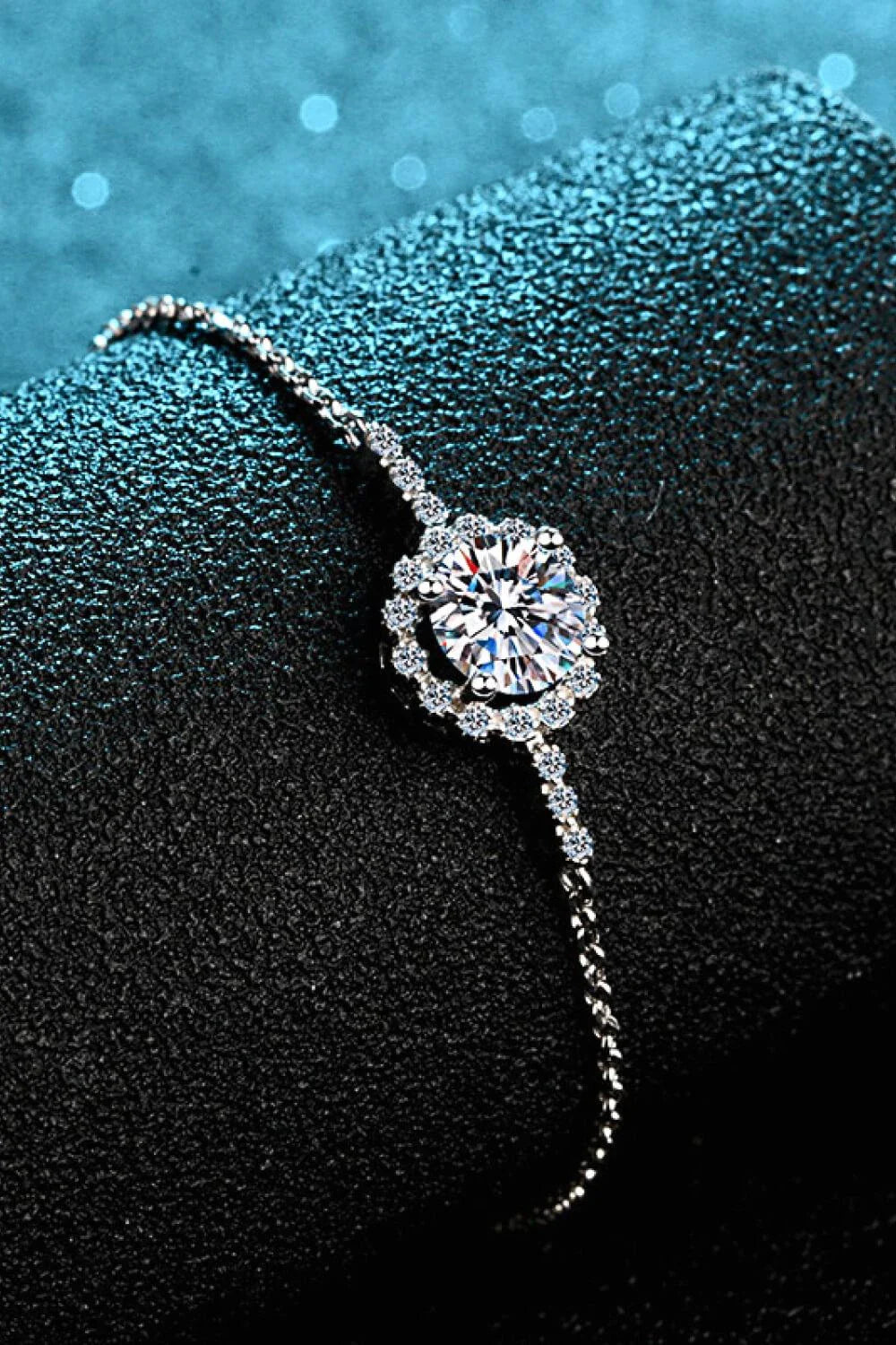 A close-up of a 1 carat moissanite chain bracelet made with 925 sterling silver and zircon accent stones.