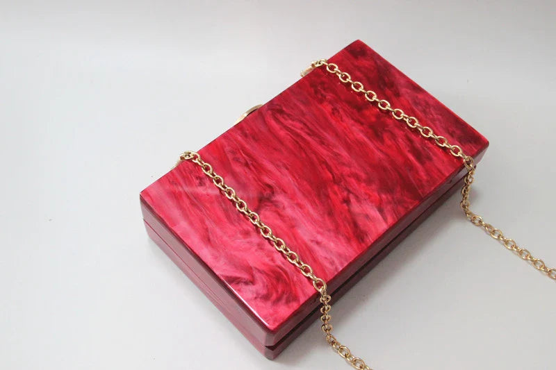 Pearlescent acrylic one-shoulder messenger bag in a stylish red colour, perfect for formal events and everyday use.