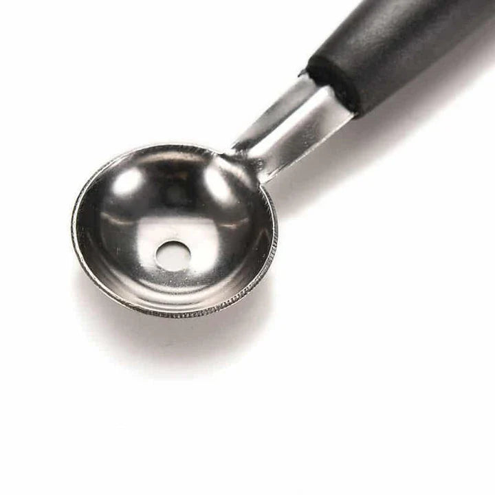 A premium double-ended stainless steel fruit carving scoop for creating intricate, Instagram-worthy culinary displays