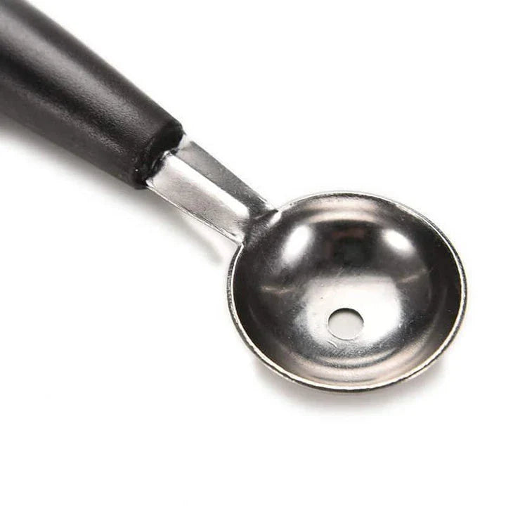 A premium double-ended stainless steel fruit carving scoop for creating intricate, Instagram-worthy culinary displays