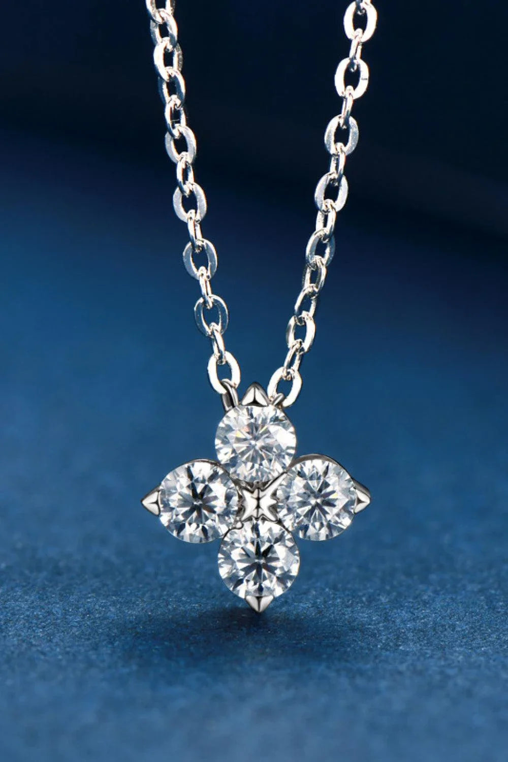 Moissanite four-leaf clover pendant necklace in sterling silver, a modern and elegant accessory with a touch of luck and charm.