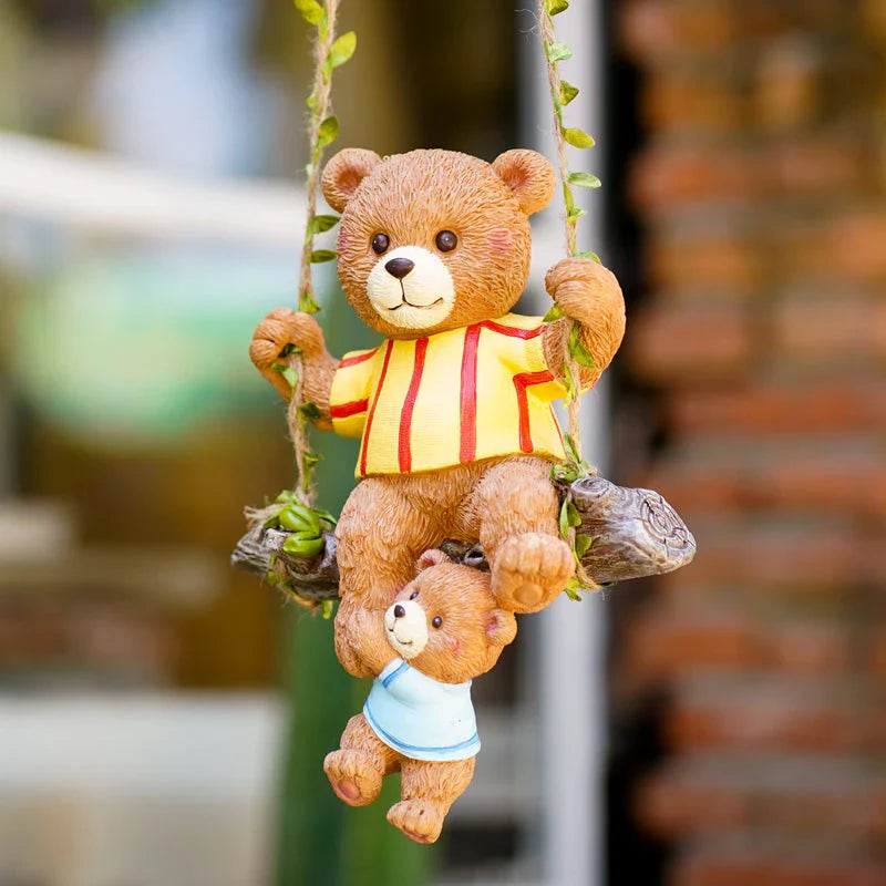 Charming resin ornament depicting a mother bear and her child on a swing, adding a touch of whimsy and warmth to any decor