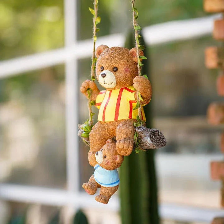 Charming resin ornament depicting a mother bear and her child on a swing, adding a touch of whimsy and warmth to any decor