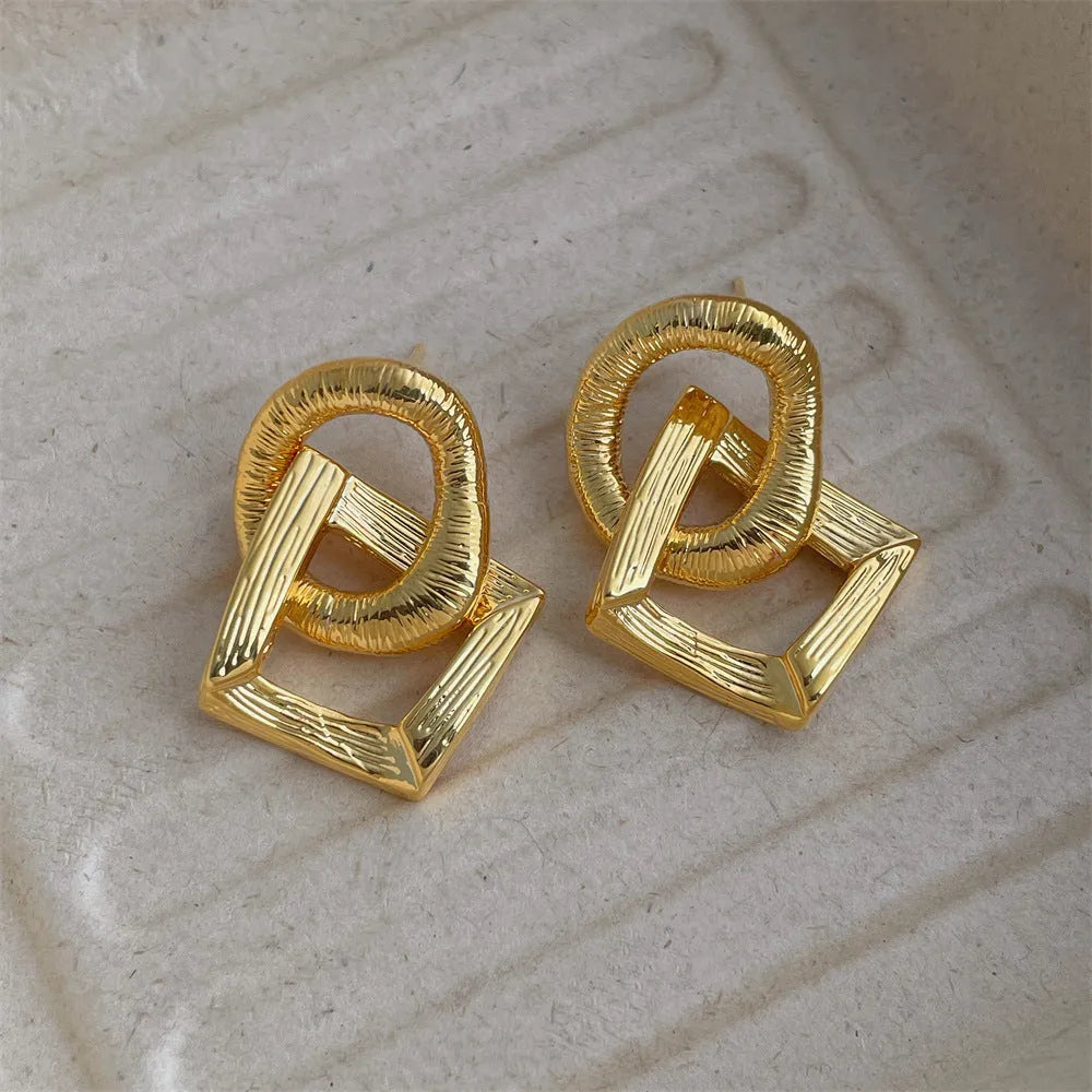 Copper geometry circle pendant earrings with electroplated gold finish measuring 3.4cm in height