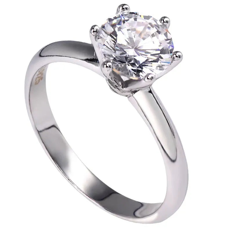 White gold plated zircon ring with six-claw setting and geometric shape on white copper base