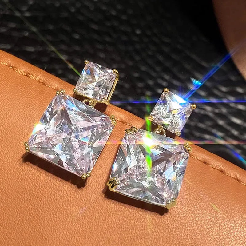 A pair of geometric square copper earrings for women in a gold colour finish.