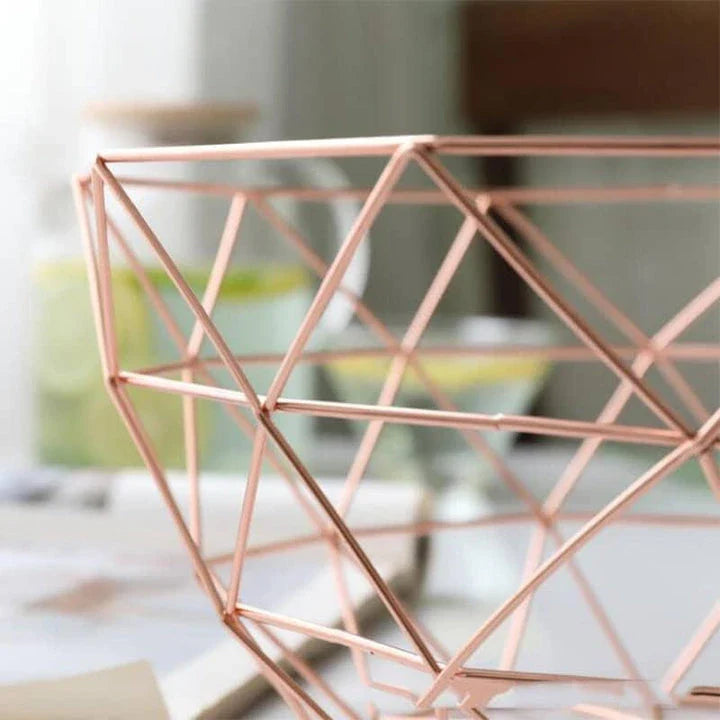 Wrought iron storage basket in black, gold, and rose gold colors, featuring a round, industrial-inspired design for versatile home organisation.