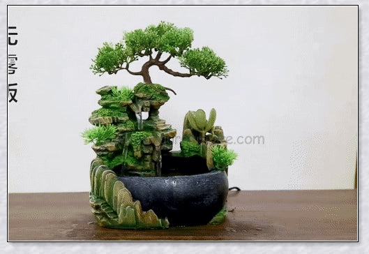 A beautiful resin tabletop fountain with flowing water, mimicking a river down a mountainside.