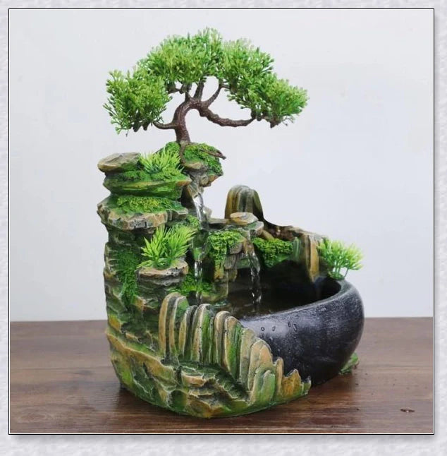 A beautiful resin tabletop fountain with flowing water, mimicking a river down a mountainside.