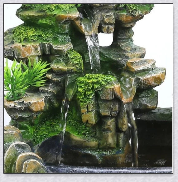 A beautiful resin tabletop fountain with flowing water, mimicking a river down a mountainside.