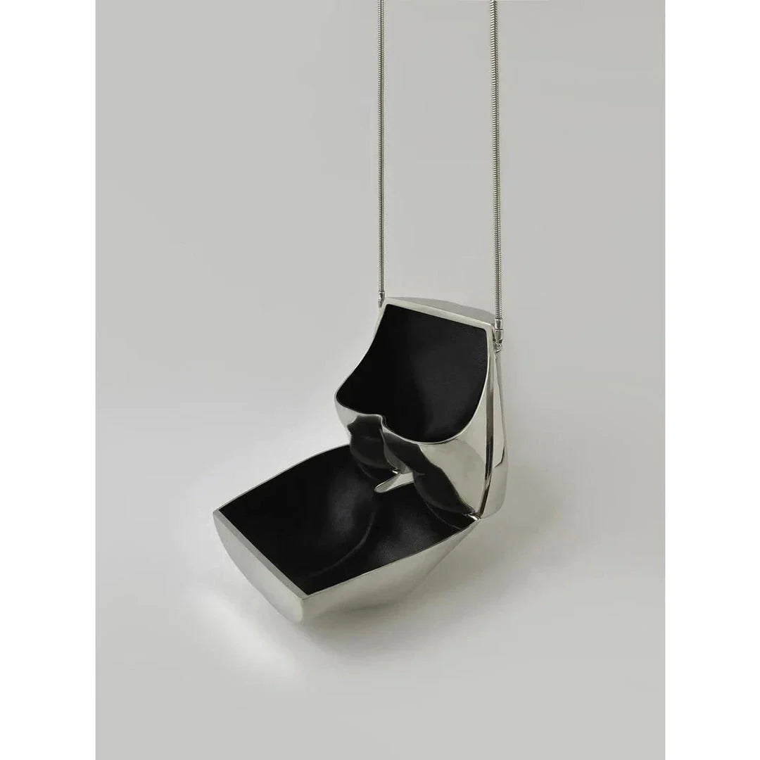 A sleek and sophisticated acrylic crossbody bag in a striking silver colour, perfect for formal events and evening occasions.