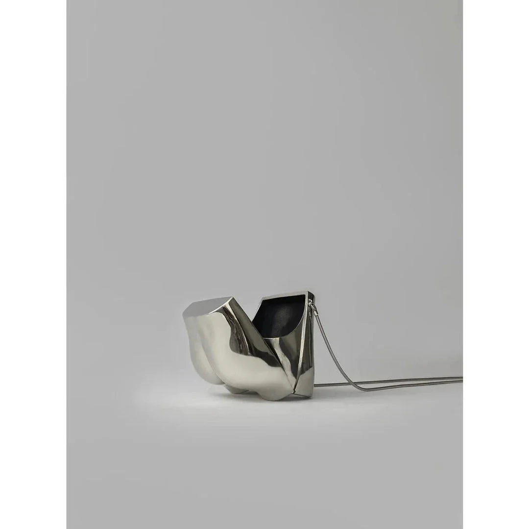 A sleek and sophisticated acrylic crossbody bag in a striking silver colour, perfect for formal events and evening occasions.