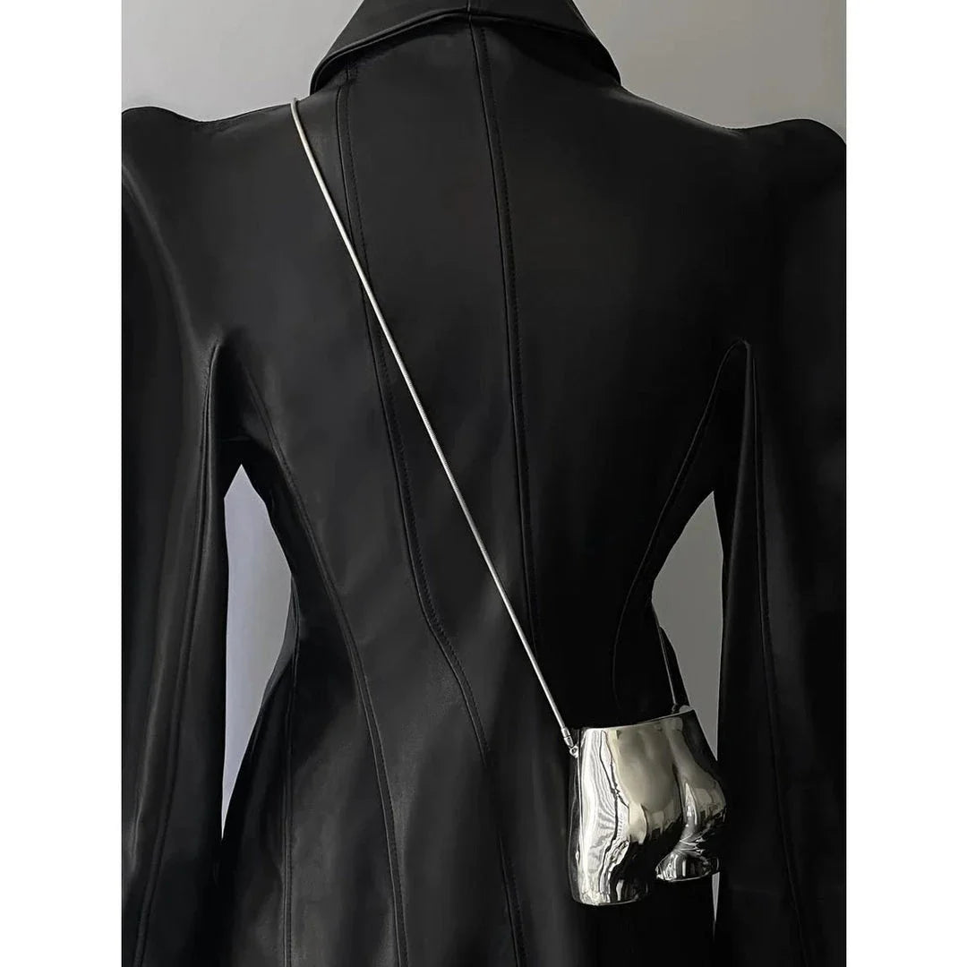 A sleek and sophisticated acrylic crossbody bag in a striking silver colour, perfect for formal events and evening occasions.