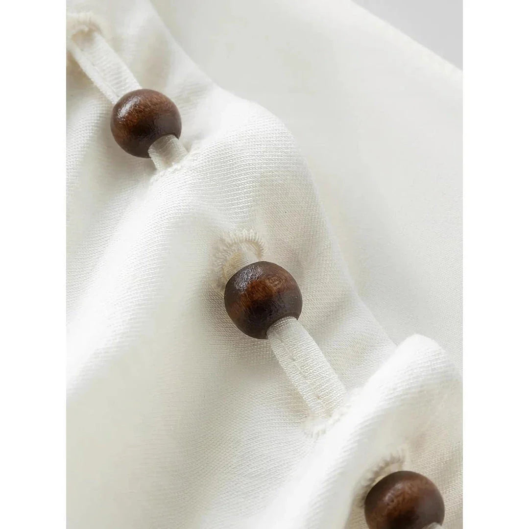Elegant Chinese-inspired dress with a romantic, sophisticated design in creamy-white colour