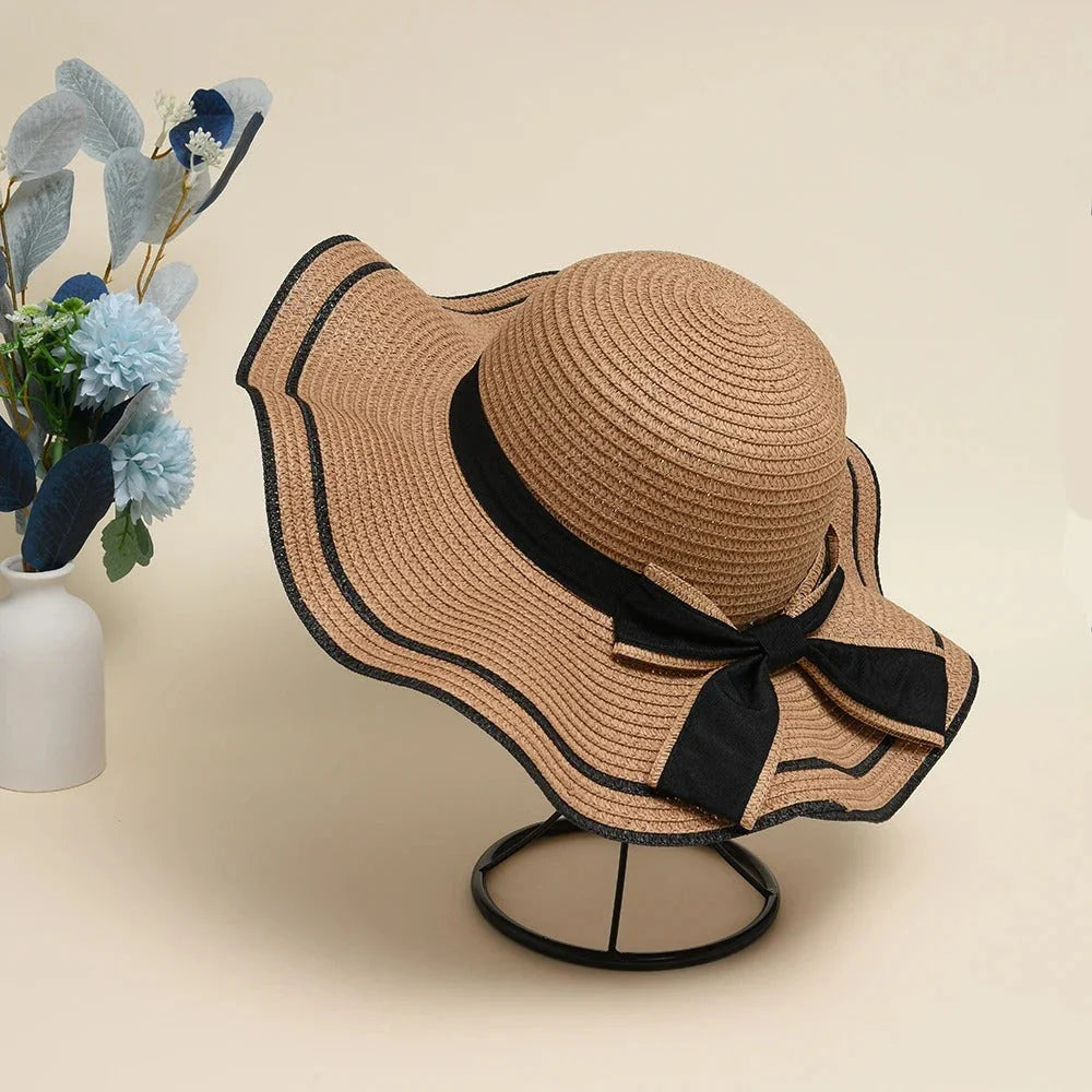 A stylish bowknot straw sun hat providing excellent UV protection and comfort for summer adventures