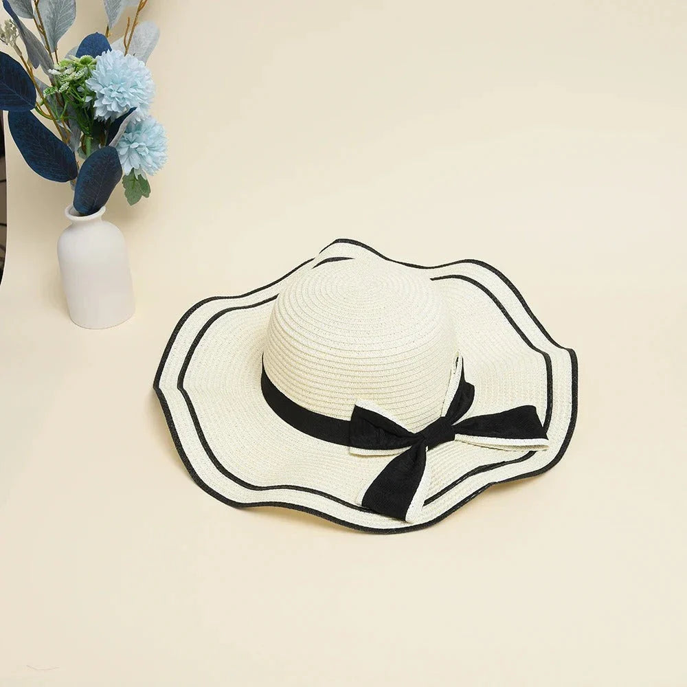 A stylish bowknot straw sun hat providing excellent UV protection and comfort for summer adventures