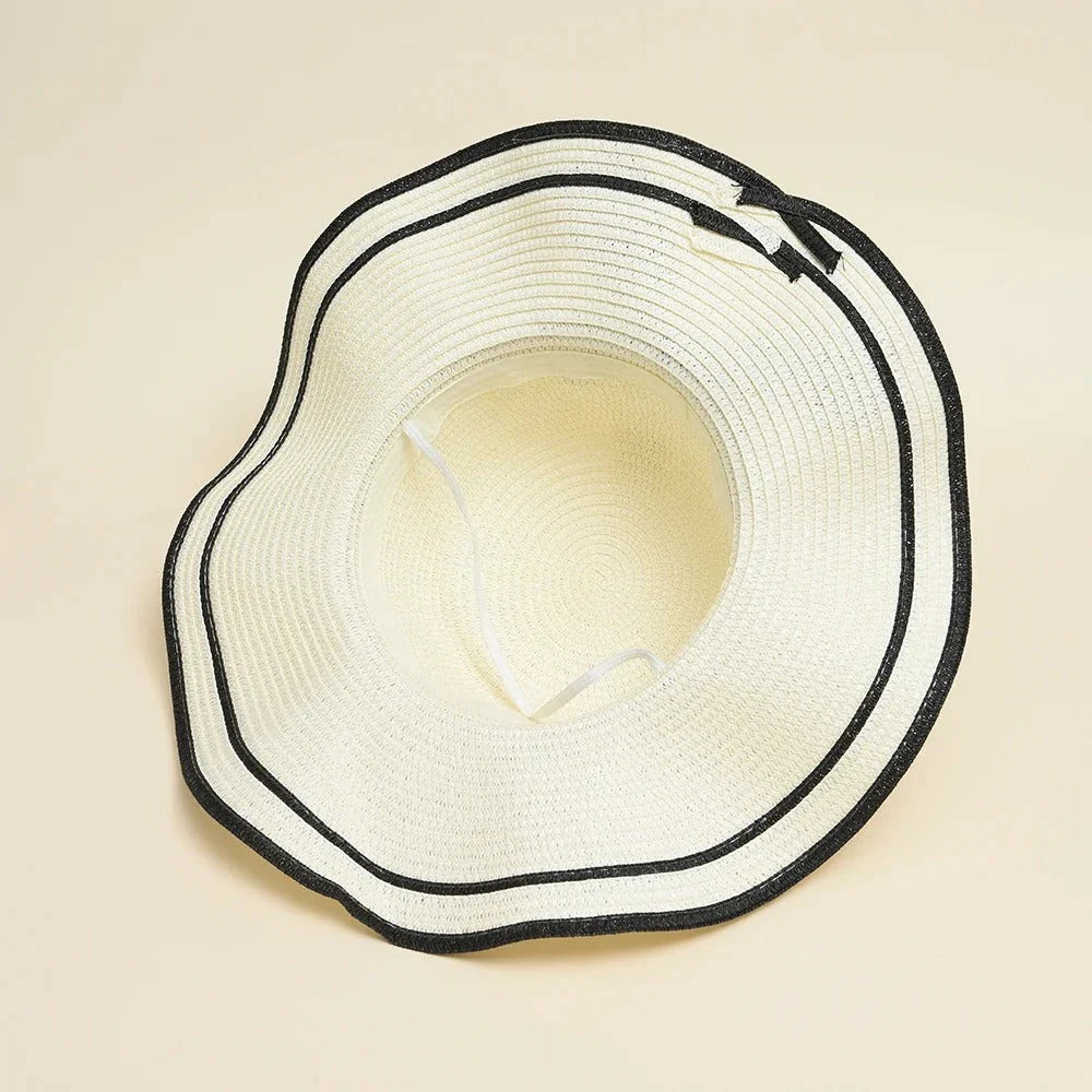 A stylish bowknot straw sun hat providing excellent UV protection and comfort for summer adventures
