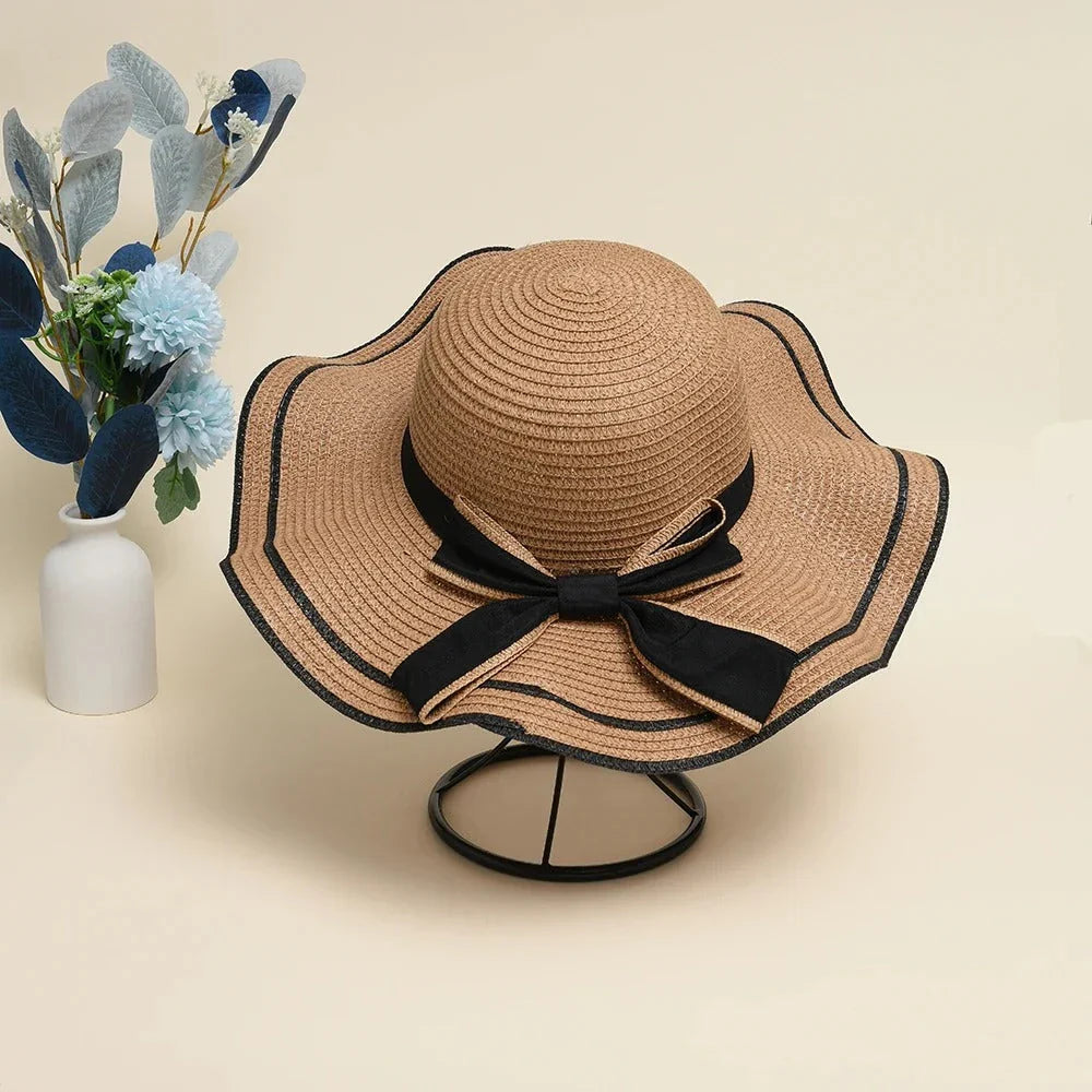 A stylish bowknot straw sun hat providing excellent UV protection and comfort for summer adventures