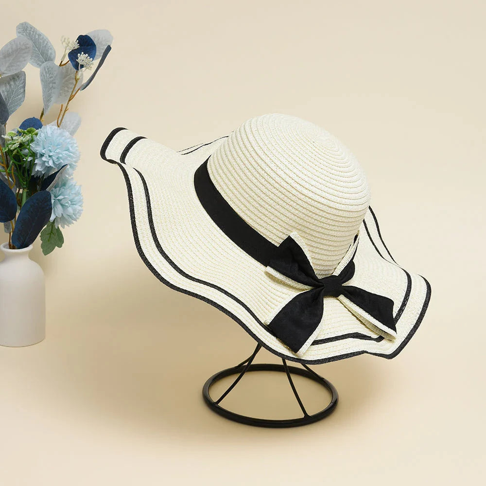 A stylish bowknot straw sun hat providing excellent UV protection and comfort for summer adventures