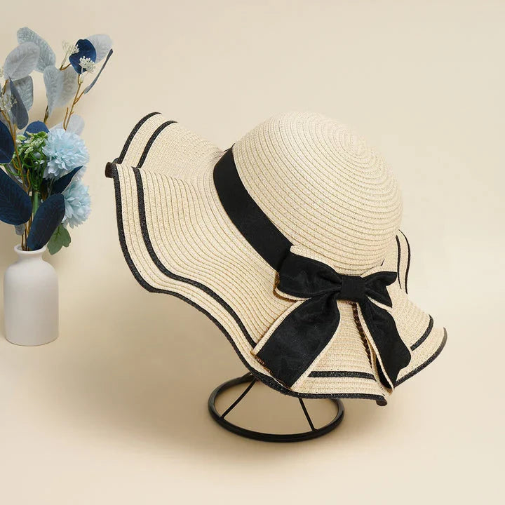 A stylish bowknot straw sun hat providing excellent UV protection and comfort for summer adventures