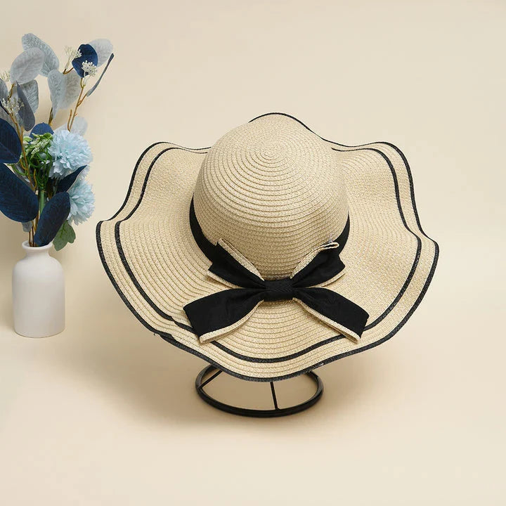 A stylish bowknot straw sun hat providing excellent UV protection and comfort for summer adventures