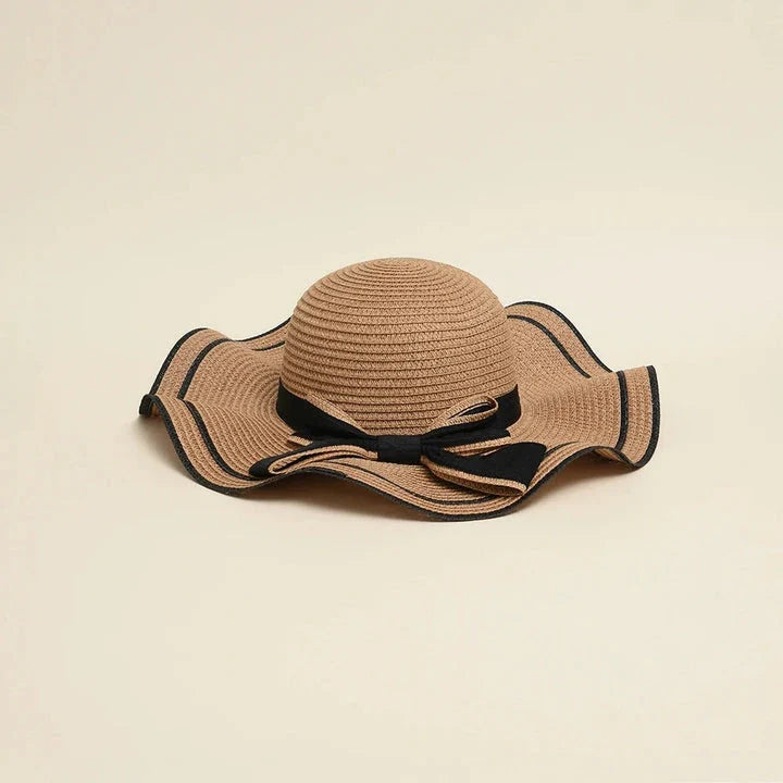 A stylish bowknot straw sun hat providing excellent UV protection and comfort for summer adventures