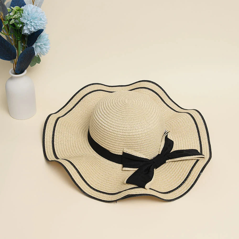 A stylish bowknot straw sun hat providing excellent UV protection and comfort for summer adventures