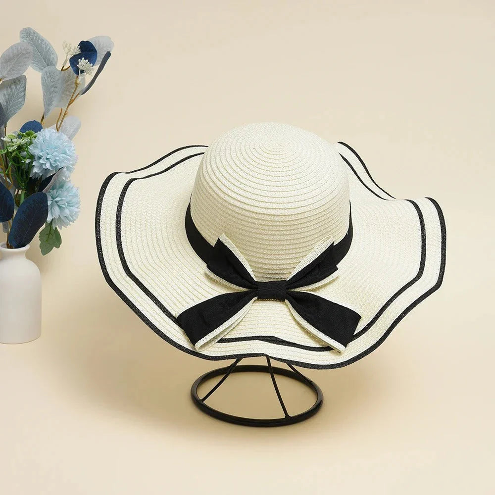 A stylish bowknot straw sun hat providing excellent UV protection and comfort for summer adventures