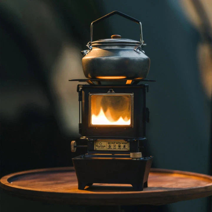 Portable retro oil lamp stove with a warm, flickering light for outdoor camping and picnics