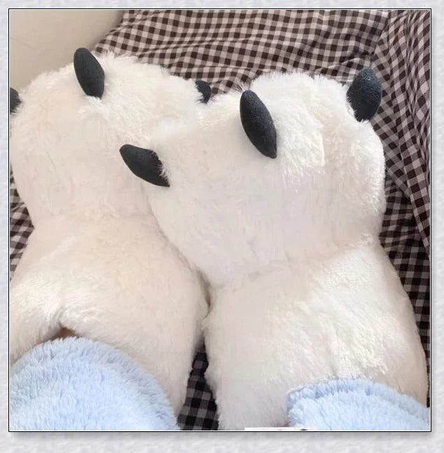 Oversized fluffy white bear claw winter slippers with a cosy and playful design, suitable for adults and kids alike