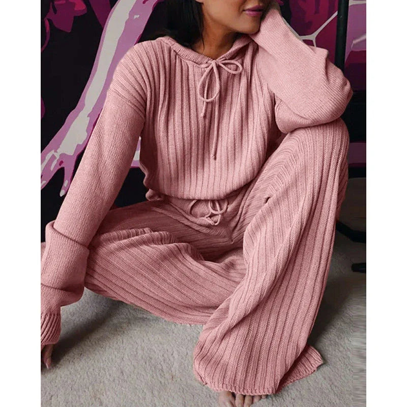 A stylish two-piece casual set featuring a hooded top with long sleeves and matching bottoms in a variety of vibrant colors.