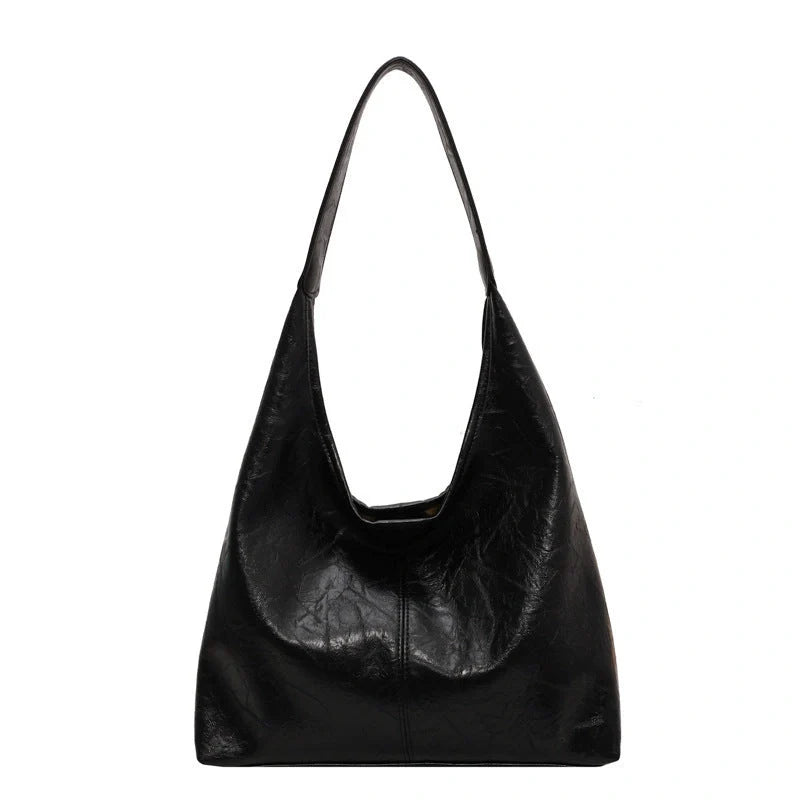 Classic vintage-inspired women's shoulder bag in a range of sophisticated colours, featuring a roomy interior, adjustable strap, and premium materials for timeless British style.