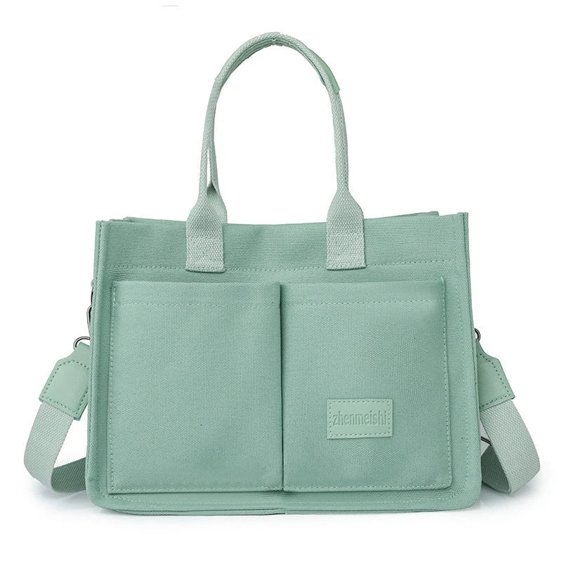Premium canvas tote bag with multiple pockets, adjustable shoulder strap, and stylish design for everyday use
