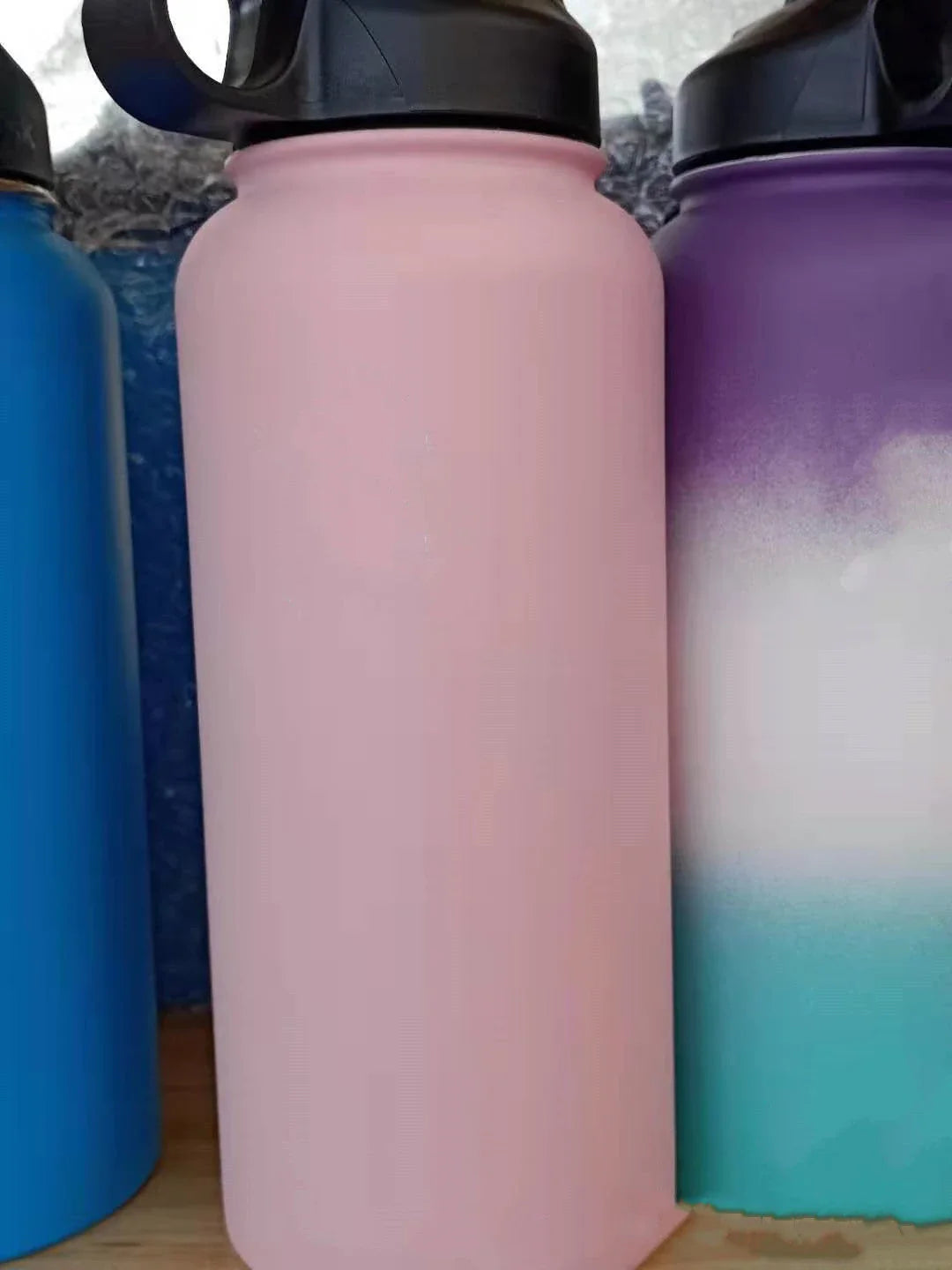 Stainless steel insulated water bottle with wide mouth and push-button lid for hot and cold beverages