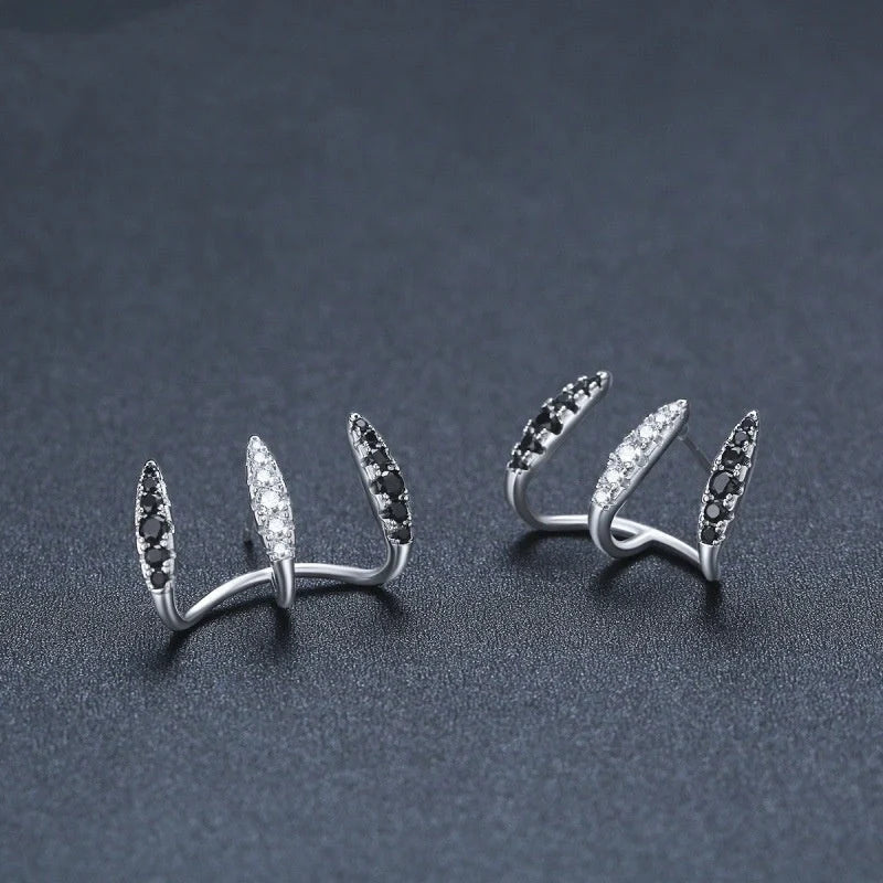 Elegant copper and zircon ear cuffs with a geometric design, showcasing British style and sophistication.