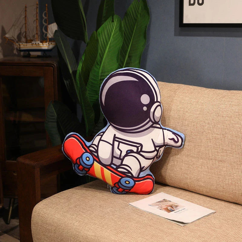 Soft plush astronaut pillows in various space-themed designs, including rockets, spacecraft, and more