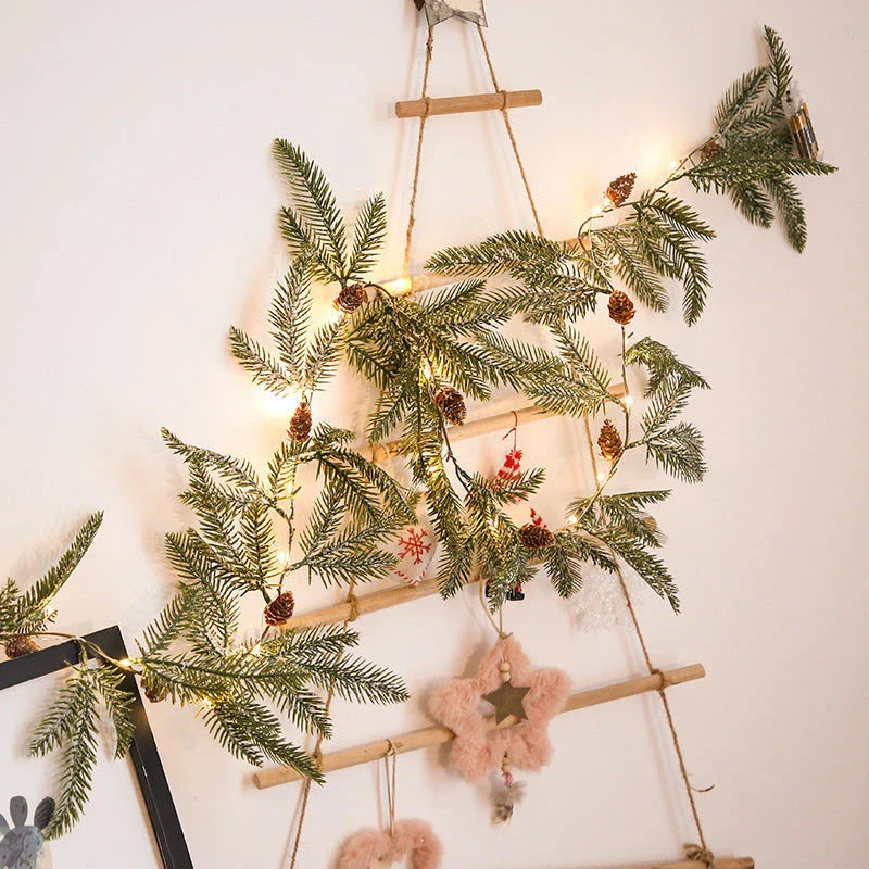 Decorative copper leaf string lights with rattan and pine needle accents, creating a cozy, festive atmosphere