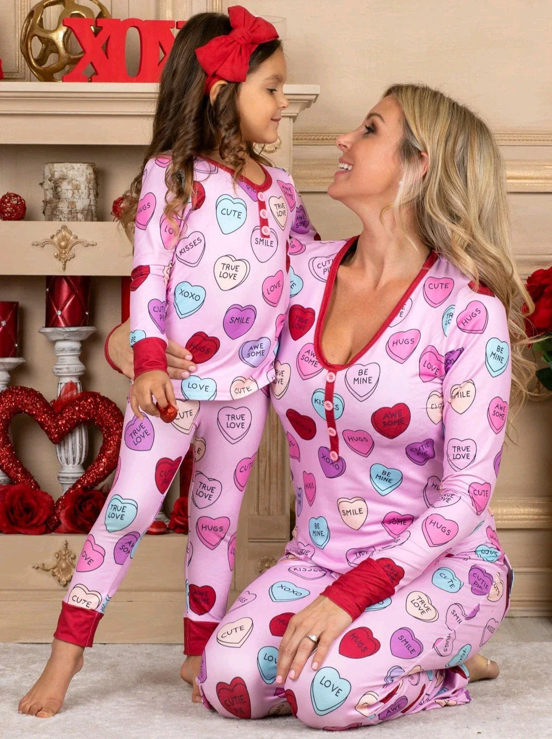 Adorable heart-printed family pajamas with long-sleeve tops and full-length bottoms in a range of sizes for children and adults.