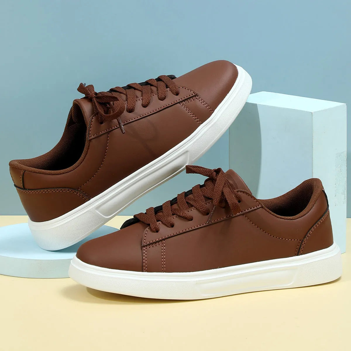 Casual beige brown platform skateboard sneakers with a low-top PU upper, round toe, and cross-strap detail