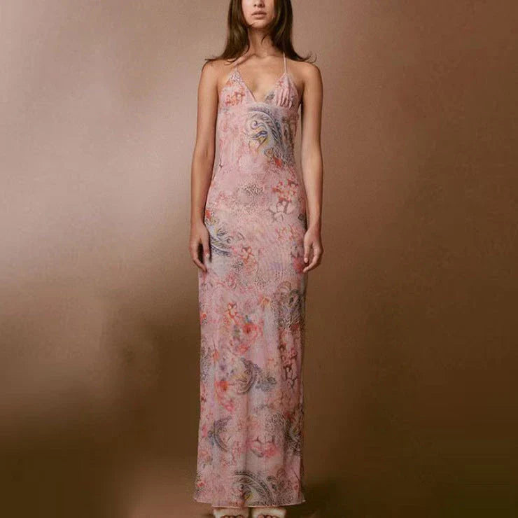 A stylish halter dress with a floral print and butterfly-inspired back, perfect for summer events and parties.